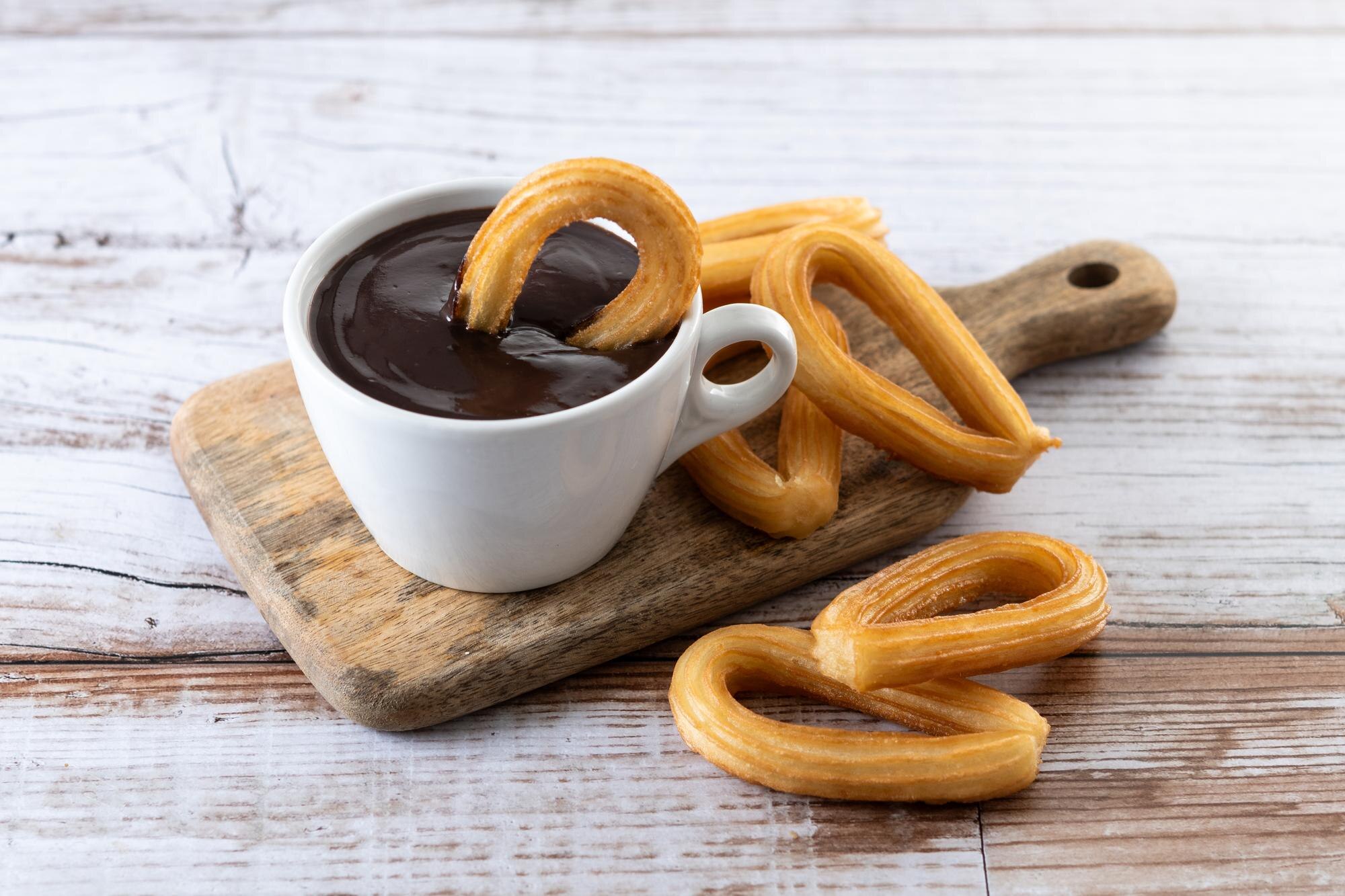 traditional spanish churros with hot chocolate breakfast wooden table 123827 27251